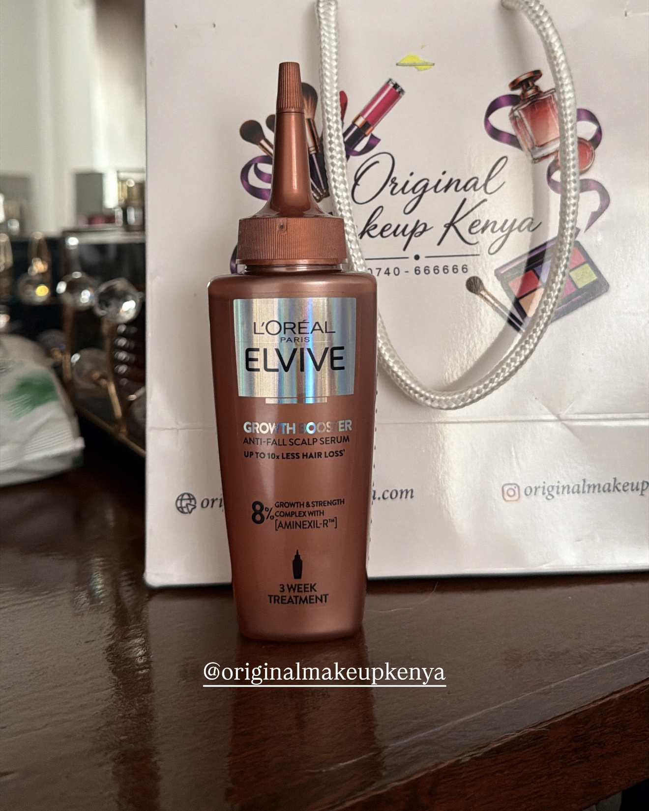 L’Oréal Elvive Growth Booster scalp serum beside an Original Makeup Kenya shopping bag